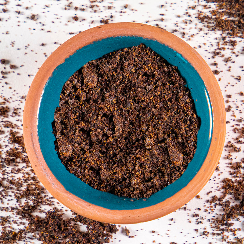Elderberries Powder herb in blue clay bowl with white background and herb surrounding.