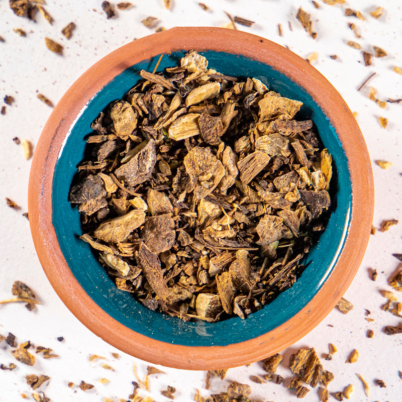 Elecampane Root herb in blue clay bowl with white background and herb surrounding.